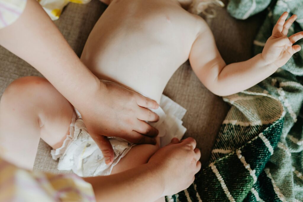 A parent changing a baby